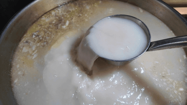 Beef bone broth boiling in pot