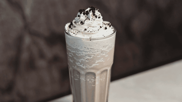 Chocolate milkshake topped with plenty of cream