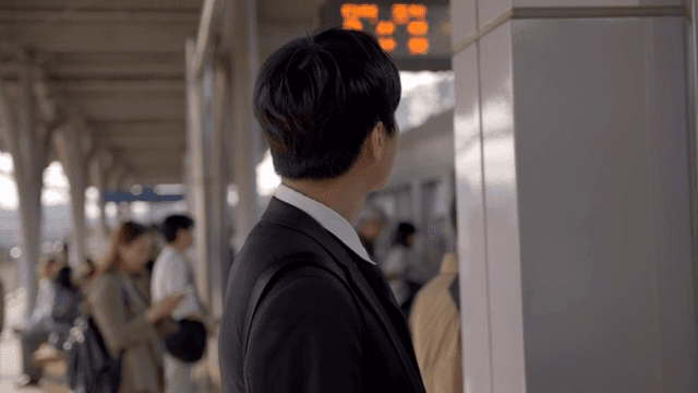 Office worker man waiting for subway at crowded subway station