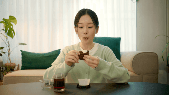 Woman eating sweet dojokku at home