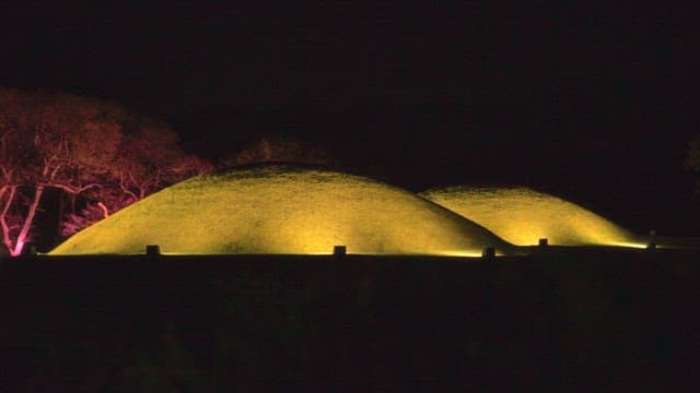 Illuminated ancient mounds from the Silla Dynasty with colorful trees at night