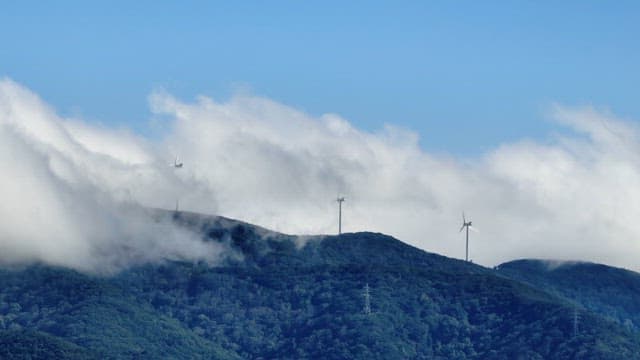 Wind turbines on a misty mountain