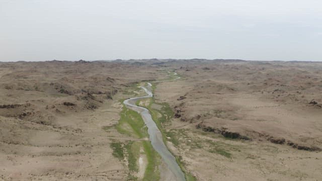 River Winding Through a Barren Desert Landscape