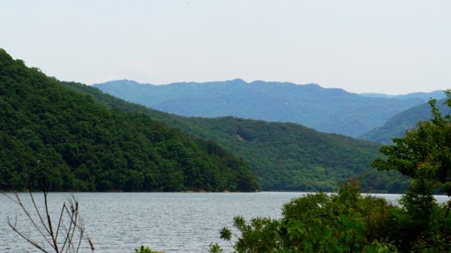 Serene mountain lake surrounded by lush greenery