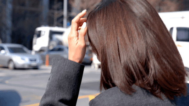 Working woman walking through busy intersection