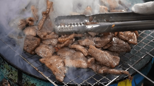 Grilled meat sizzling on a barbecue