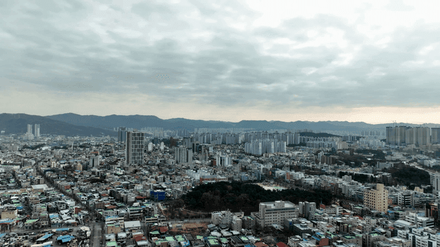 City landscape spread out under cloudy sky