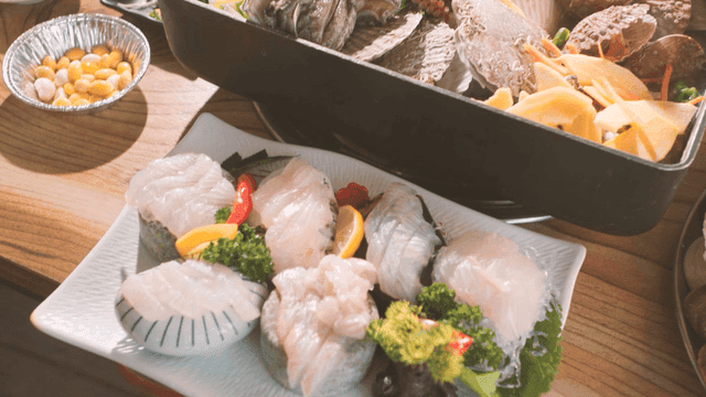 Table with variety of steamed seafood and raw fish