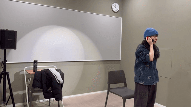 방에서 전화 통화 중인 여성