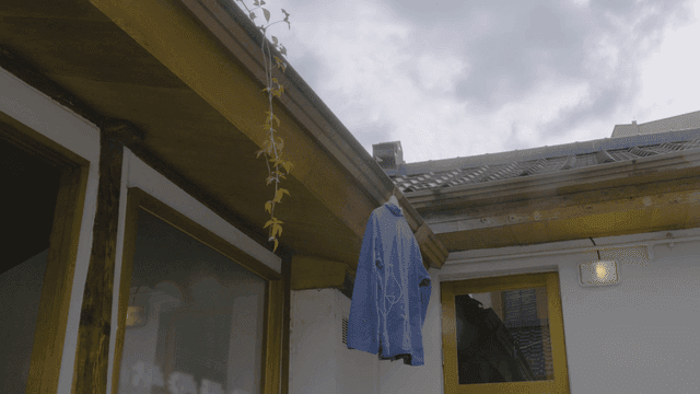 Traditional Hanok with blue jacket hanging