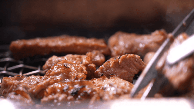 Sizzling grilled marinated pork ribs on barbecue