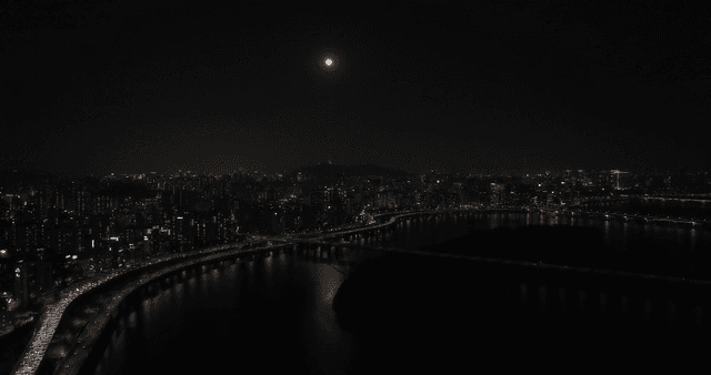 Moonlit city skyline with river view