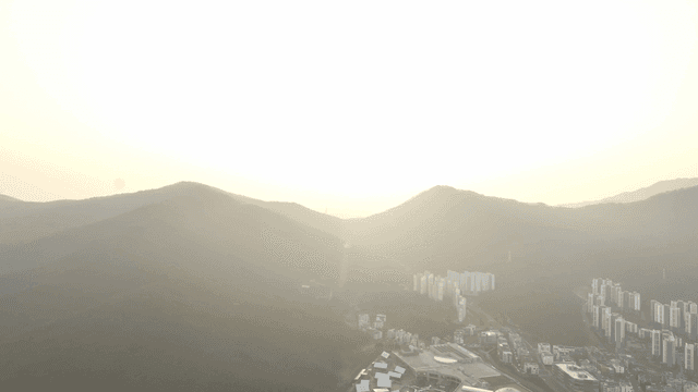 Sunrise nestled between mountains