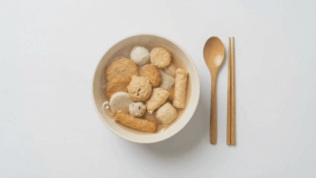 Bowl of various fish cake soup in broth
