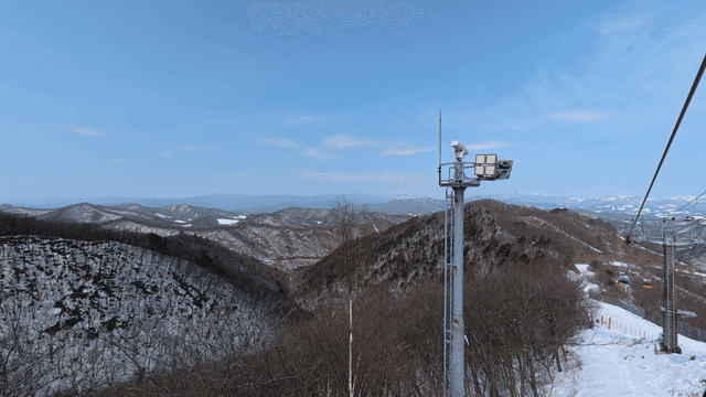 Snowy mountain landscape with ski lift