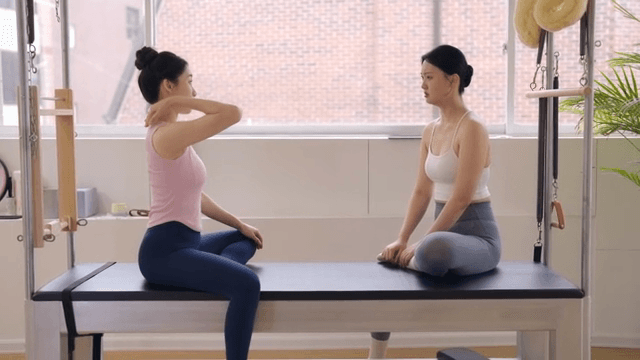 Two women discussing in a fitness studio