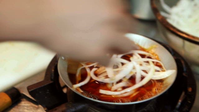 양파가 끓고 있는 냄비에 올라가는 돈까스