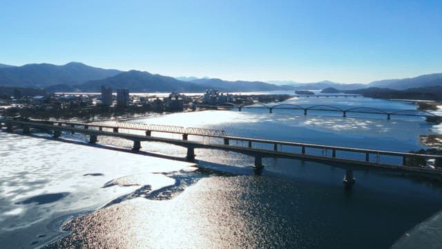 Winter Landscape with Bridge Over Frozen River