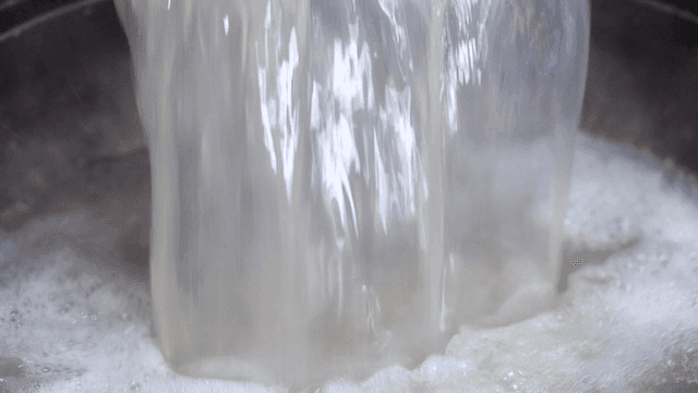 Hot broth poured into pot
