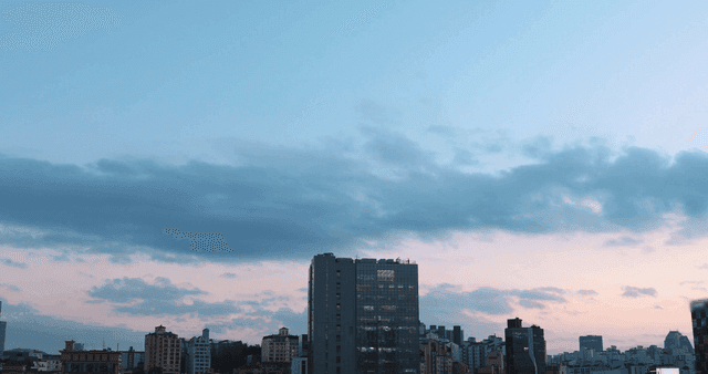 City skyline at dusk with clouds