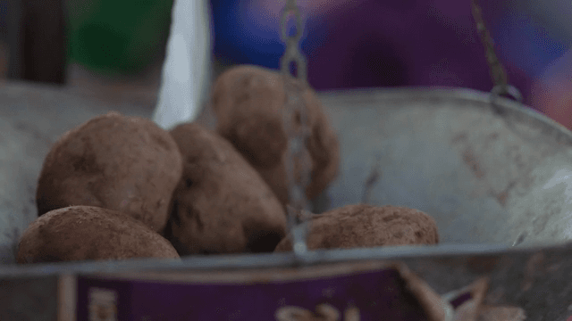 Potatoes being weighed on a scale