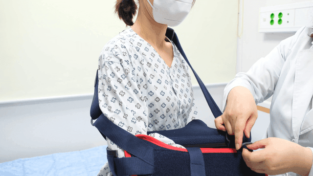 Female patient receiving arm support at hospital