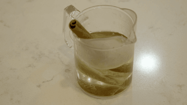 Beaker with herbal tea and cinnamon