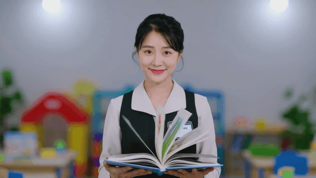 Kindergarten teacher reading book in classroom