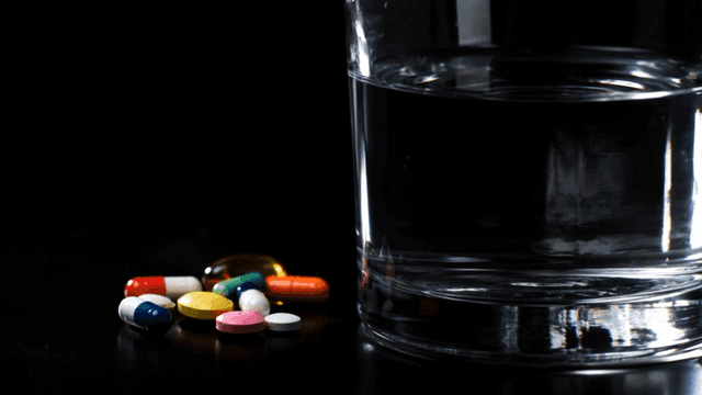 Glass of water and pills