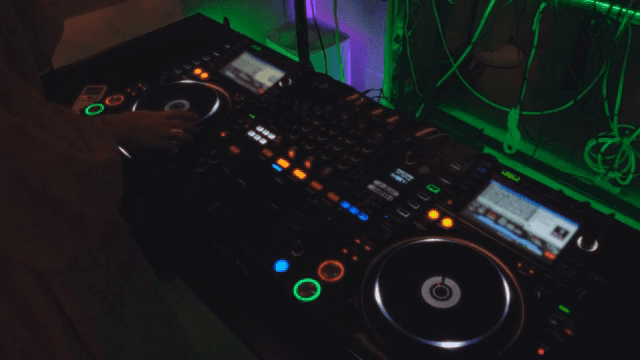 DJ mixing music in a dark space