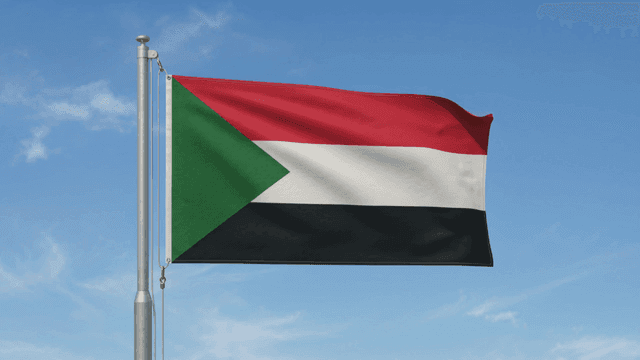 Sudanese flag fluttering against clear sky