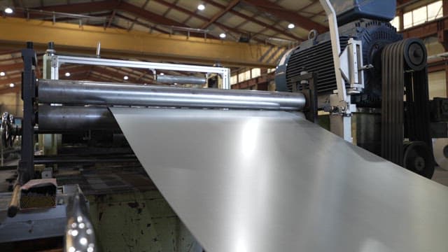 Metal sheet being processed in a factory