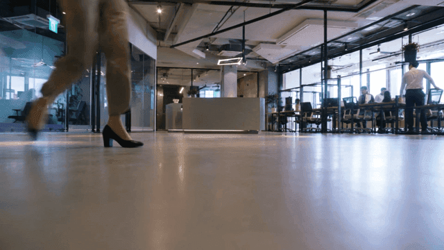 Open-plan office where office workers pass by