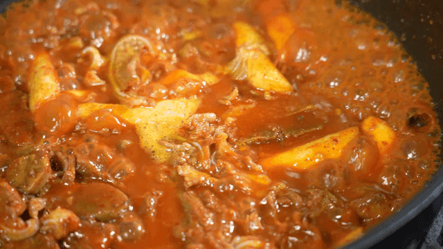 Spicy braised crunchy pork ribs boiling in pot