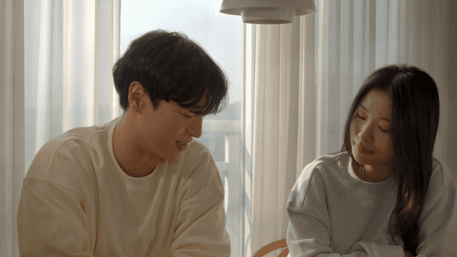 Couple smiling and talking by the window