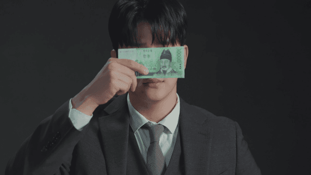 돈으로 얼굴을 가리며 상반된 표정을 보이는 남자