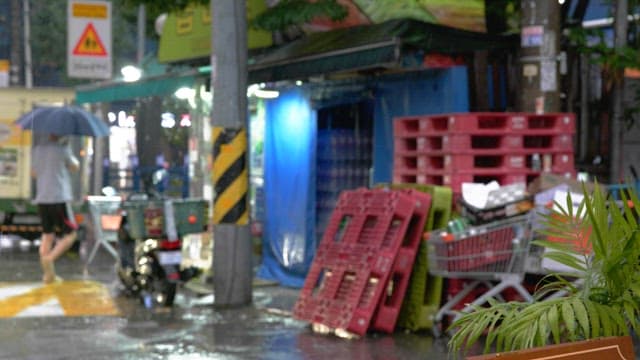 Alley with a supermarket in sight on a rainy day