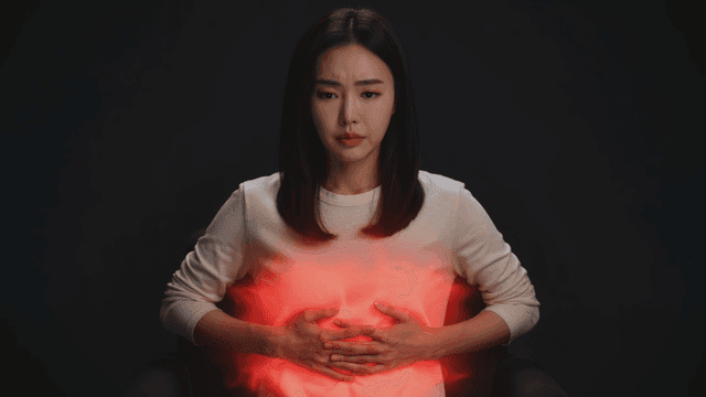 Woman focusing on her breathing with hands on her abdomen