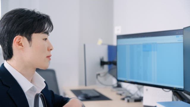 Man sitting at his office desk and talking on the phone