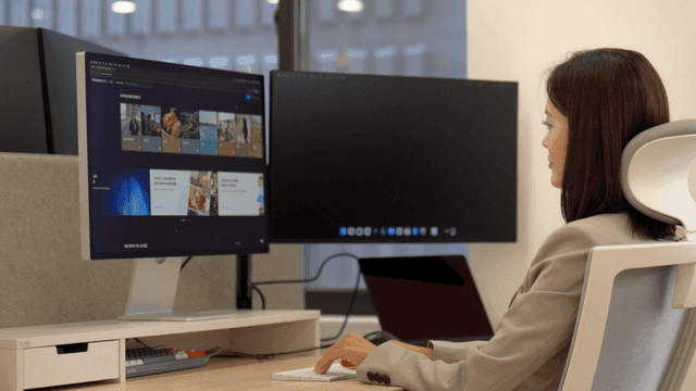 Female office worker using dual monitors