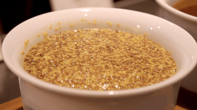 Whole grain mustard in white bowl