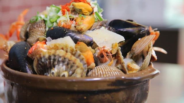 Variety of seafood such as clams and shrimp in a pot