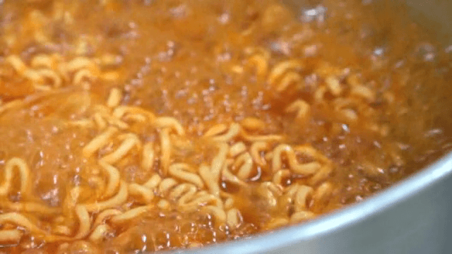 Ramyeon noodles boiling in a pot