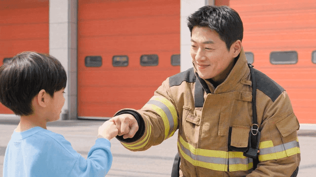 Firefighter and child exchanging fist bump