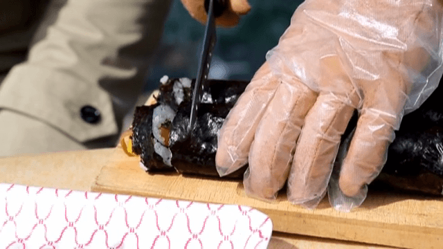 Cutting Gimbap on a wooden board