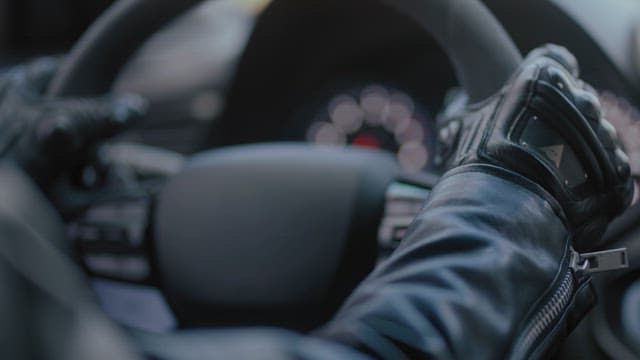 Person driving a car with focus on hands