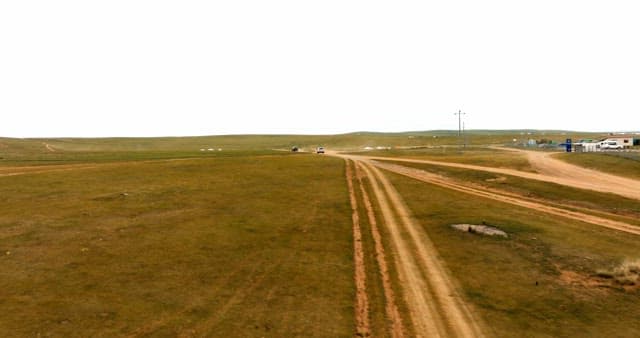 Wide open grasslands with dirt roads