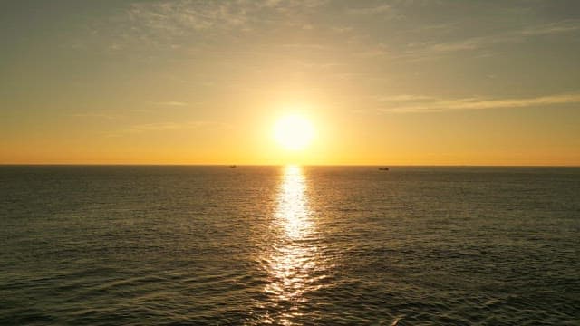 Sunset over the calm ocean horizon