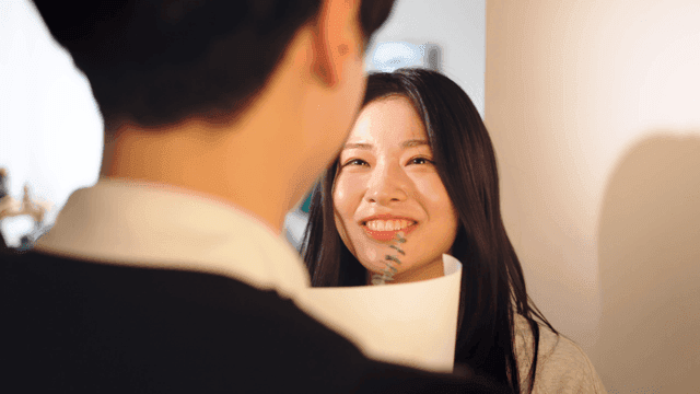 Couple happily receiving flowers at home