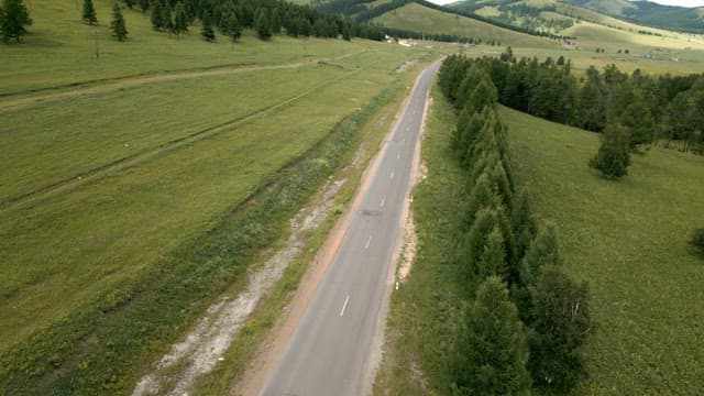 Winding road through lush green hills